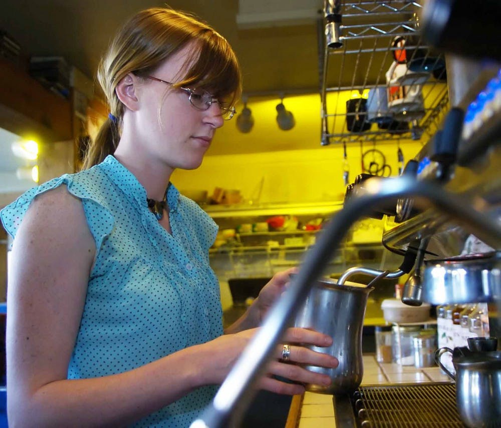 Barista Alex Blosson steams milk for a cappuccino Monday at the Blue Dragon Coffeehouse.  