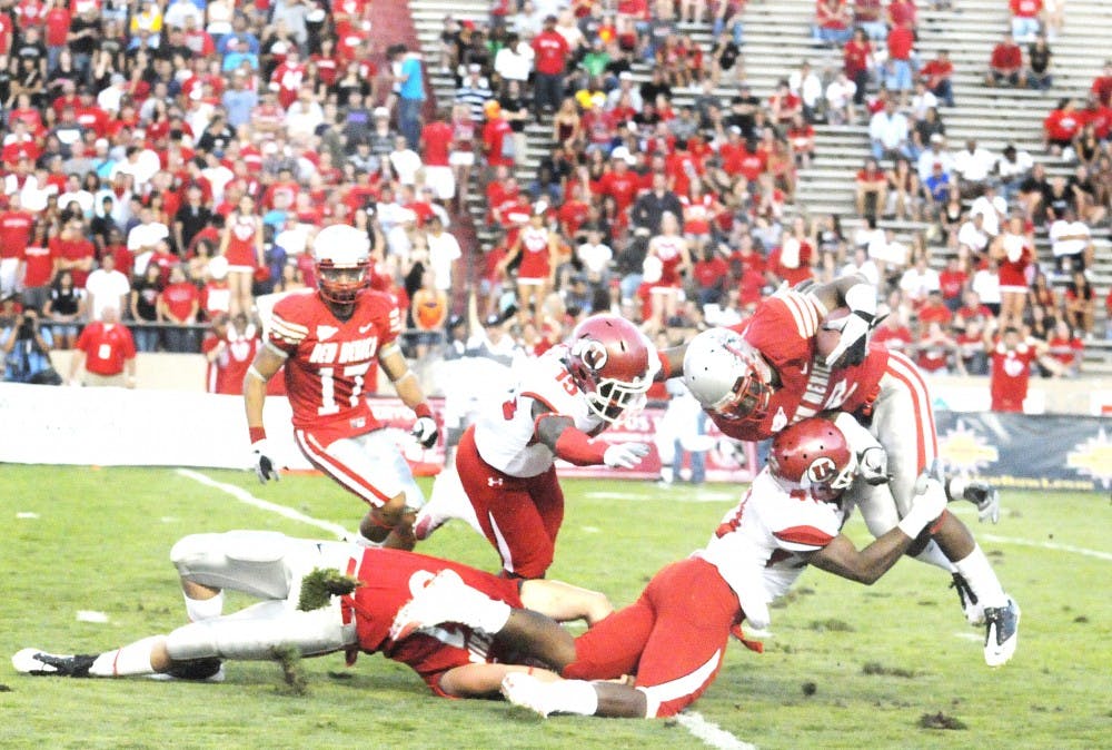 	UNM cornerback Emmanuel McPherson is tackled by Utah’s special teamers. The Utes defeated the Lobos 56-14 on Saturday.