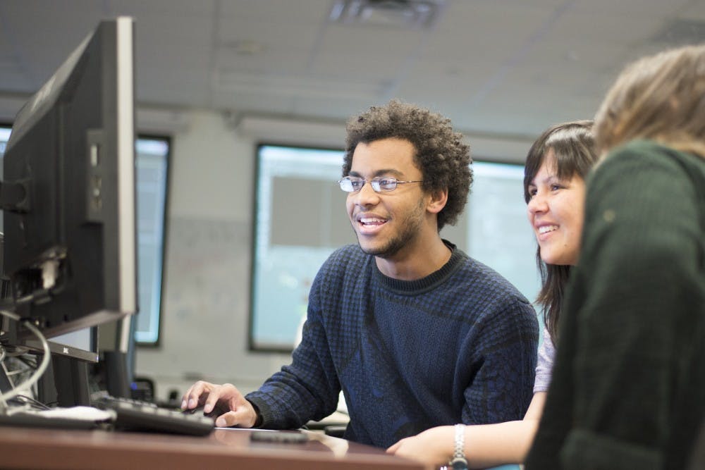 Paris Premdas, Aroonsri Khamsamran and Marlene Rios look through movie clips in undergoing post production editing as they work April 7. Khamsamran and Rios are the director and producers of the IFDM programs Jubilation movie while Premdas is the post production supervisor for the movie. 