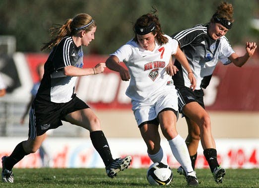 Alexis Ball goes for the ball against Drake's Blair Nelson, left, and Bailey Dorrington during Friday's game at the UNM Soccer Complex. UNM won 1-0 over Drake.