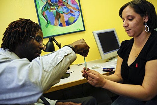 Leann Morgan tests Hakim Bellamy for HIV on Friday at Mesa Vista Hall. Bellamy helped promote Black HIV/AIDS Awareness Day on campus, which included free testing.