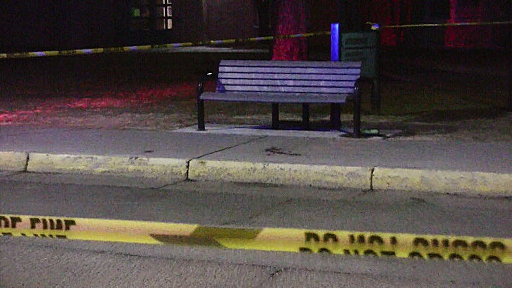 	Police tape marks off the bench near the Anthropology Building where the victim was attacked.