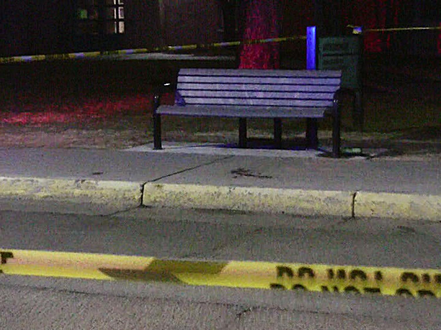 	Police tape marks off the bench near the Anthropology Building where the victim was attacked.