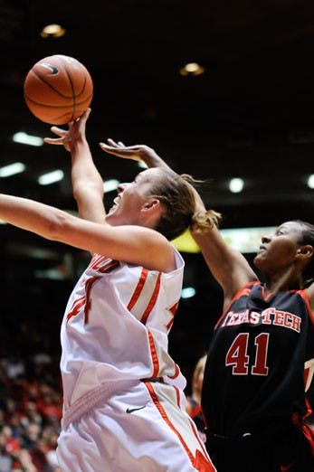 Angela Hartill shoots over Texas Tech's Dominic Seals on her way to the basket during Saturday's 63-54 win at The Pit. Hartill had 16 points and 10 rebounds. 
