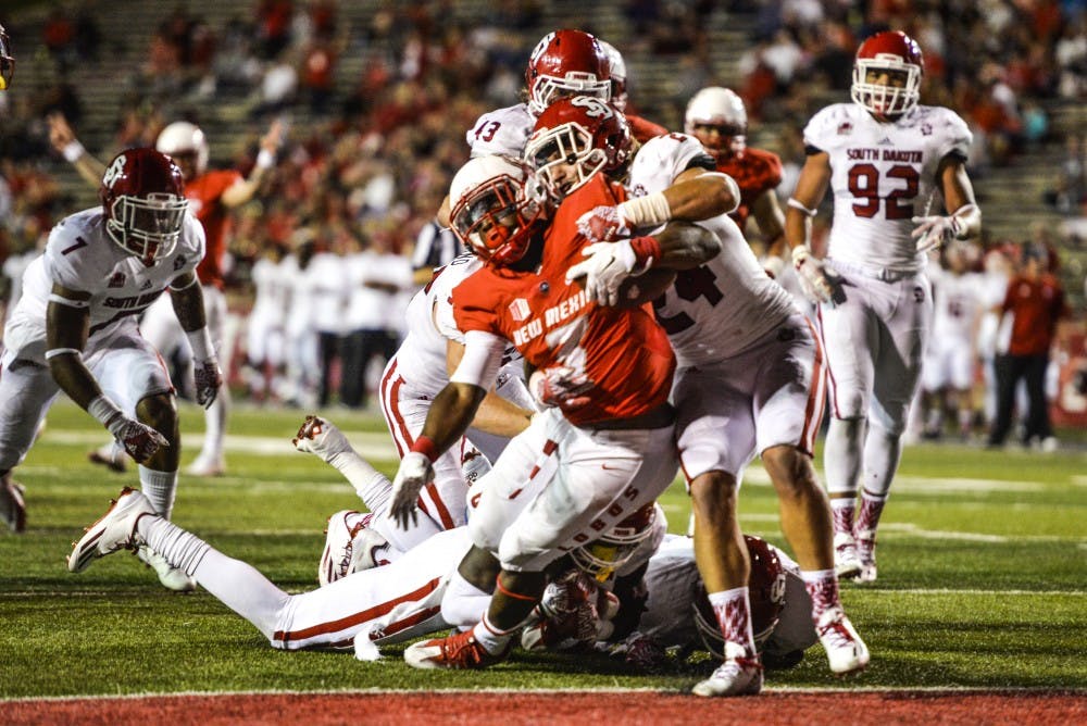 Junior running back Richard McQuarley pushes himself into the Lobos end zone to score a touch down Thursday Sept. 1, 2016 at University Stadium.
