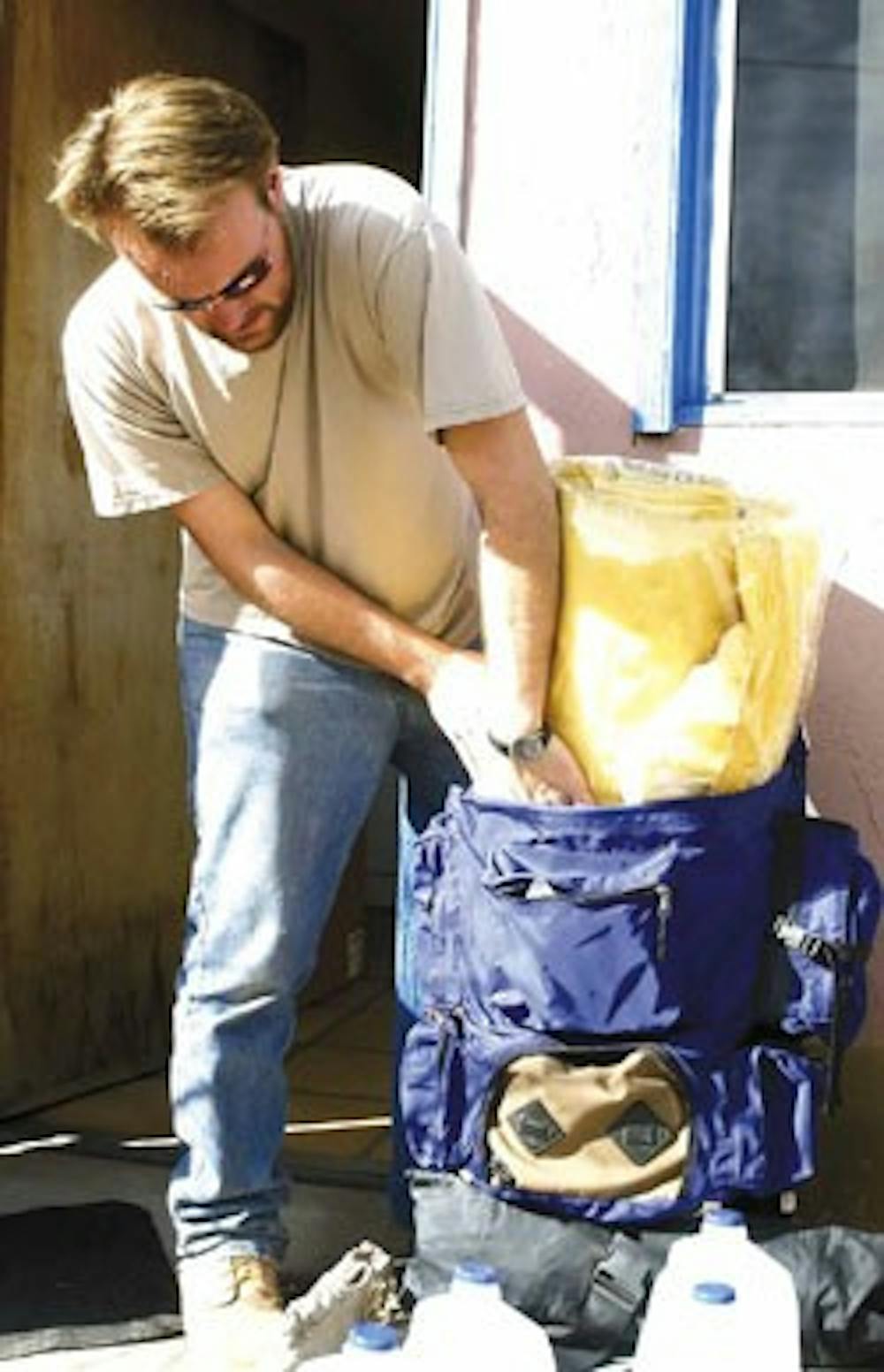 Student Phil Carter packs a mattress pad and hiking gear for the trip he'll be taking with the UNM Wilderness Alliance during spring break. The group will go to the Gila National Forest and backpack through the mountains in search of two packs of Mexican 