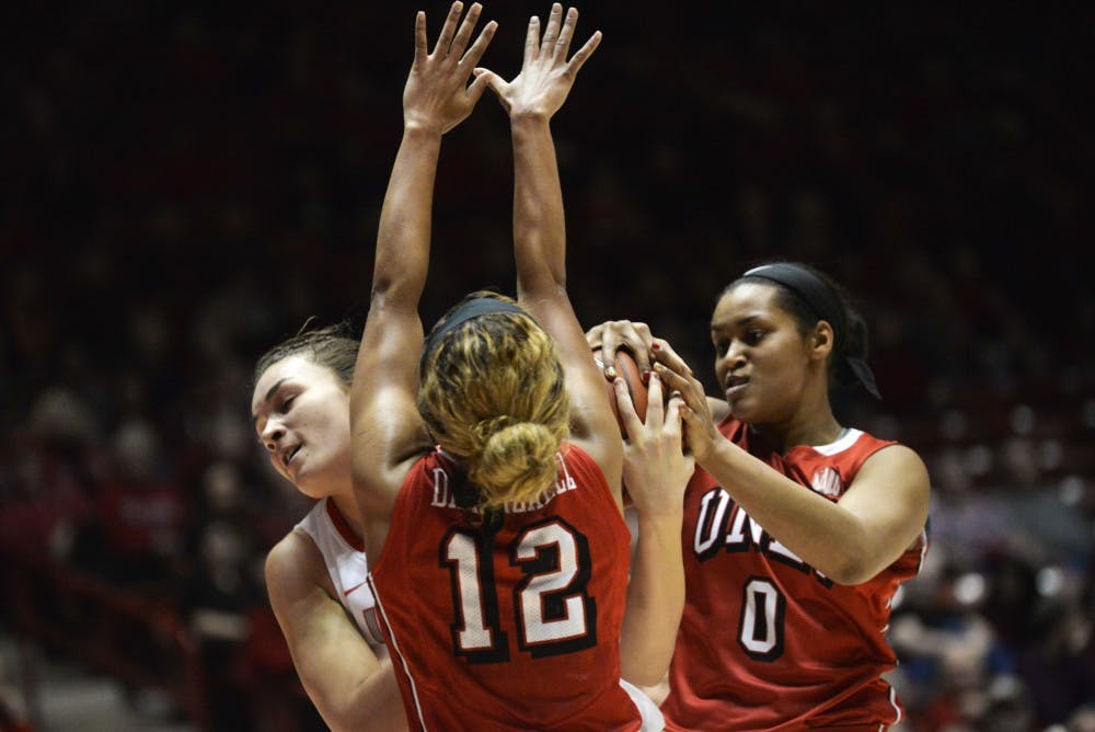 Freshman center Jaisa Nunn fights for the ball against two UNLV players Wednesday, Jan. 13, 2015 at WisePies Arena. The Lobos lost to Wyoming 66-48. 