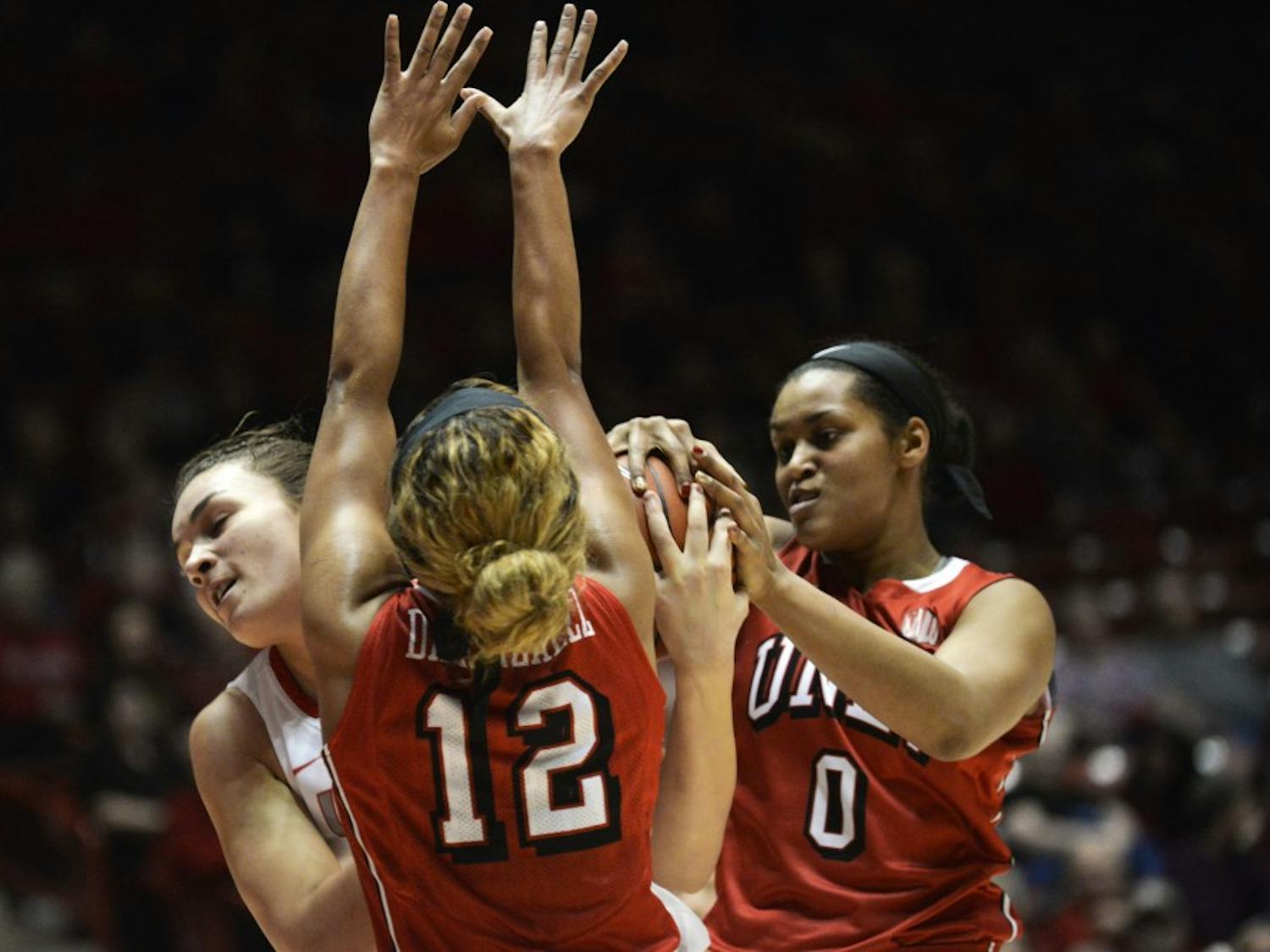 Freshman center Jaisa Nunn fights for the ball against two UNLV players Wednesday, Jan. 13, 2015 at WisePies Arena. The Lobos lost to Wyoming 66-48.