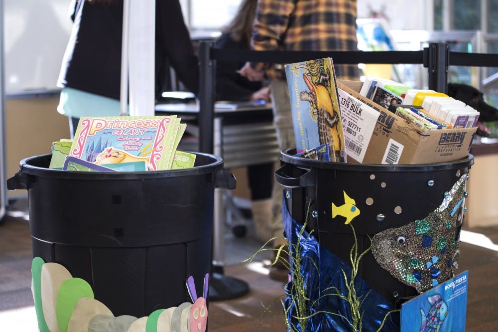 Barrels filled with donated books for The College of Education's annual book drive stand at Travelstead Hall on Nov. 18. The books go to participating teachers associated with the College of Education.