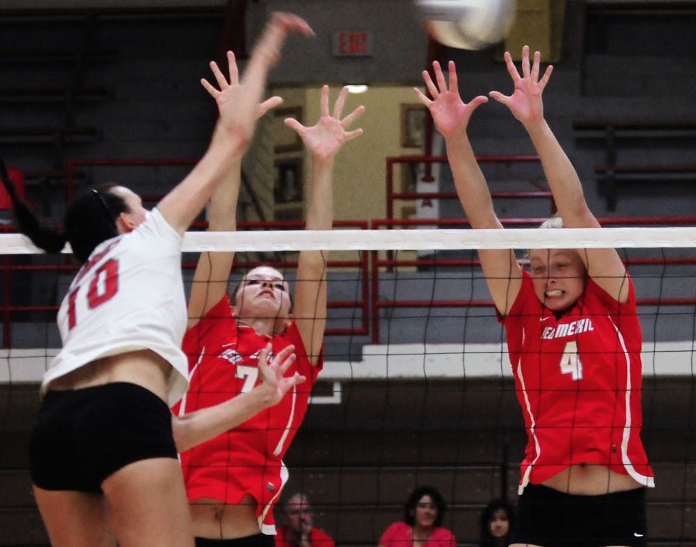 	Ashley Rhoades, right, and Jade Michaelsen defend the net during UNM’s annual cherry-silver scrimmage at Johnson Gym on Saturday.