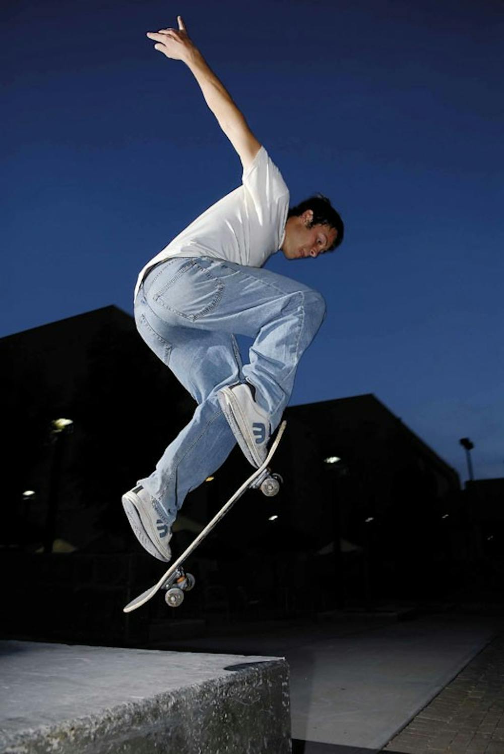 UNM student Justin Spudic ollies off a ledge near the SUB on Wednesday. 