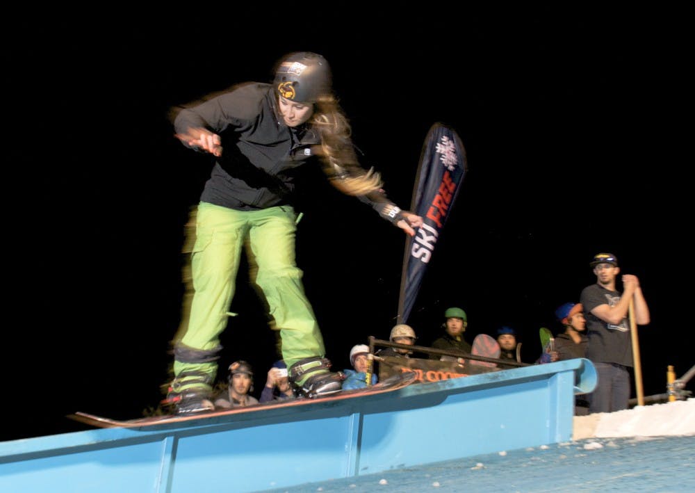 A snowboarder performs a 50 Pay50 slide on the portable rail at the fourth annual Rail Jam competition on Friday. As snowboarding and skiing season comes to a close, the hosts of this year?s Rail Jam said they wanted to give local snowboarders one last chance to compete. 