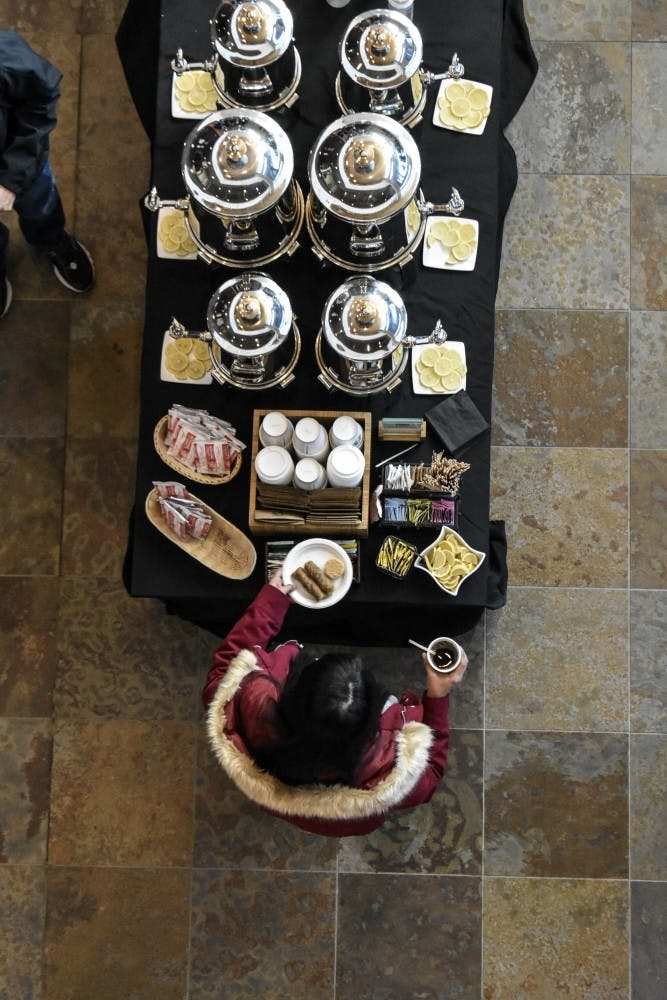 A student serves herself hot chocolate and biscochitos during the Hot Chocolate and Gratitude event on Tuesday, Nov. 27.