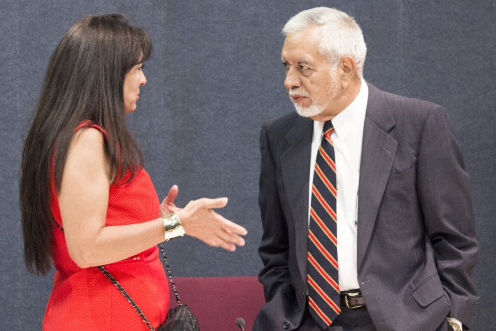 	Councilors Klarissa J. Peña and Rey Garduño discuss the agenda during the Albuquerque City Council meeting on Monday. Garduño’s resolution to pass a motion to have lower marijuana penalties put on the ballot for the next elections passed by a 5-4 vote.