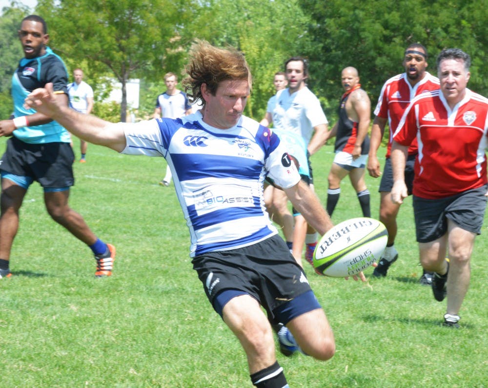 A UNM alum kicks the rugby ball to the side of the field on Saturday at Johnson Field. Men's Soccer Goalie Feature.