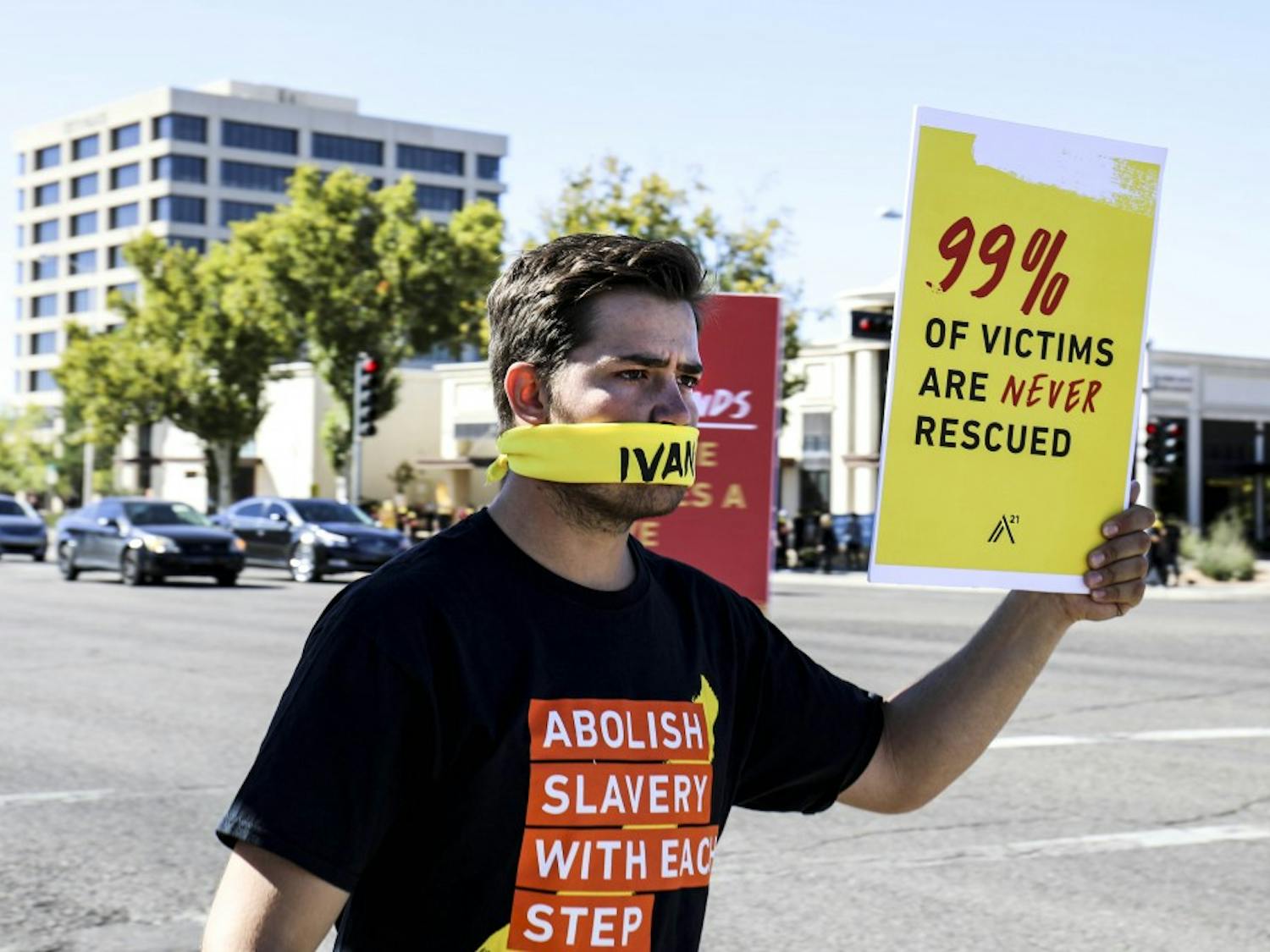 An A21 participant holds up a sign to raise awareness of modern day slavery on Oct. 14, 2017 near Uptown. Participants gathered at Lewis University before walking down to Louisiana Blvd.