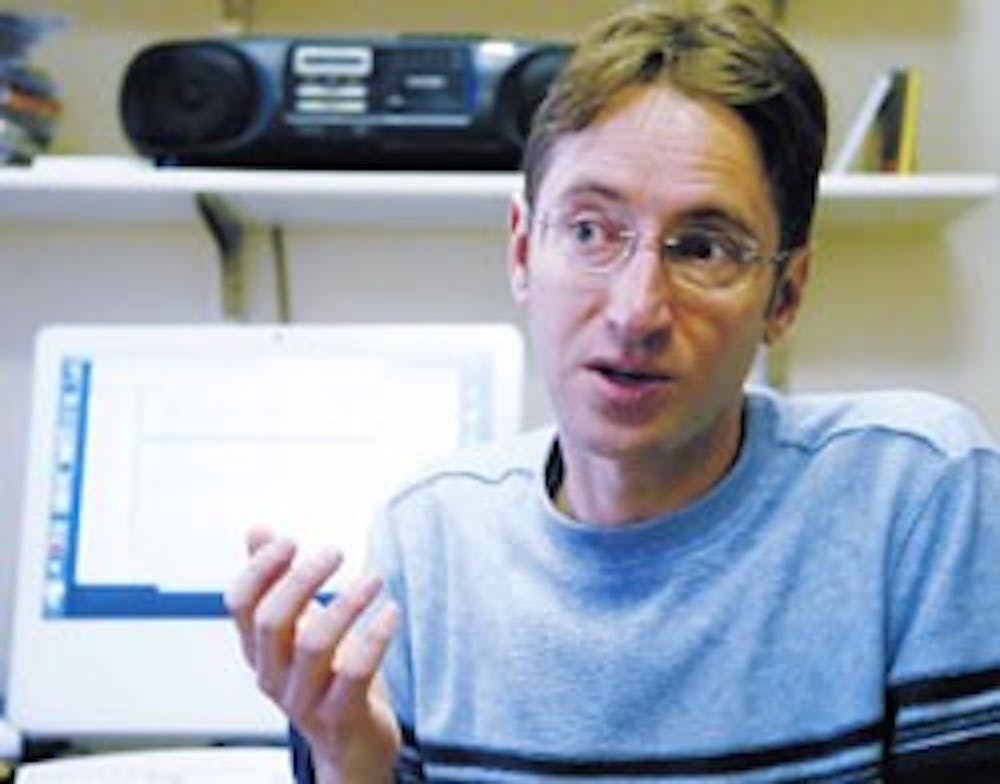 Computer science professor Jared Saia talks about the development of his algorithm program Thursday in the Ferris Engineering Center. 