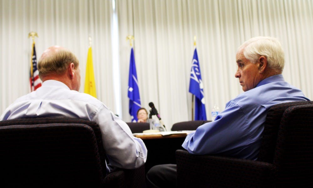 	Board Chair Jamie Koch talks with Vice Chair Don Chalmers during a break in a Lobo Development Corporation Meeting on Monday. The board met to discuss funding options for various construction projects throughout campus.