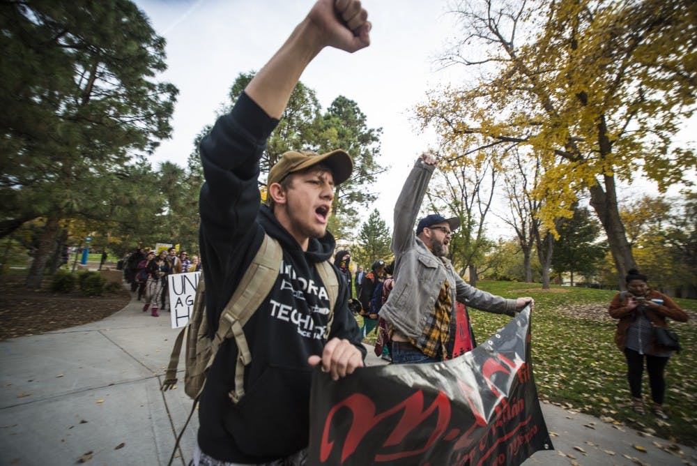 Protesters march in front of Scholes Hall in an attempt to address UNM President Bob Frank Wednesday, Nov. 16, 2016. Protesters came together in a campus-wide solidarity movement to protest President-elect Donald Trump and other issues.