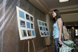 UNM graduate student Yanghee Kim, one of the first through Zimmerman Library's doors at the reopening Monday, looks at a display explaining the damage caused by April's fire.