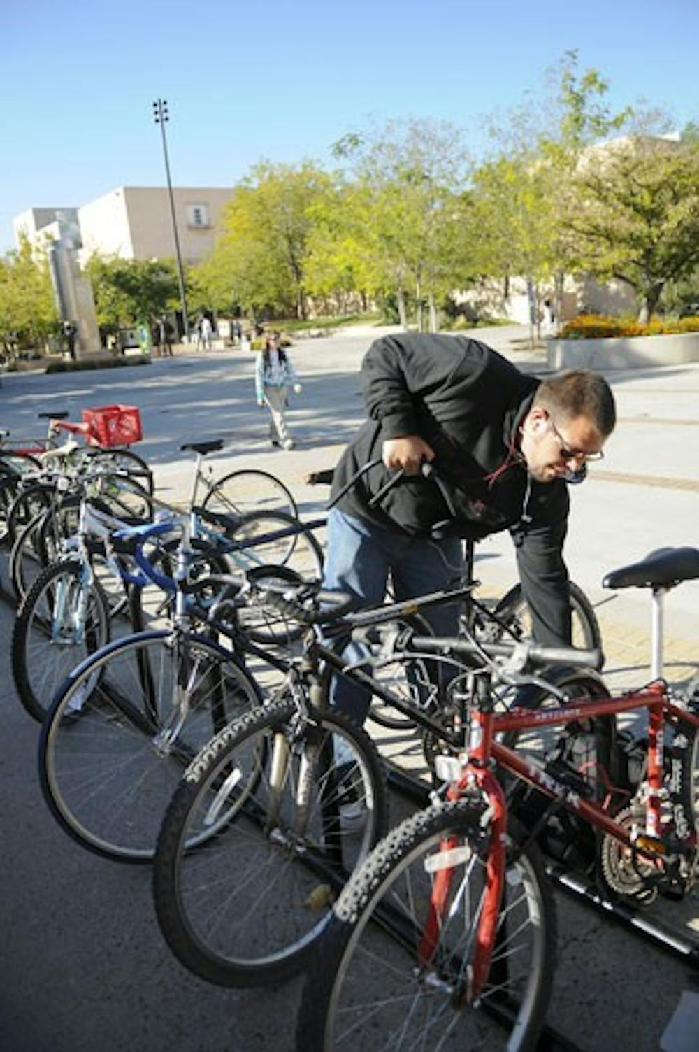 Dominic Sanchez locks his bike before going to class near the SUB on Tuesday.