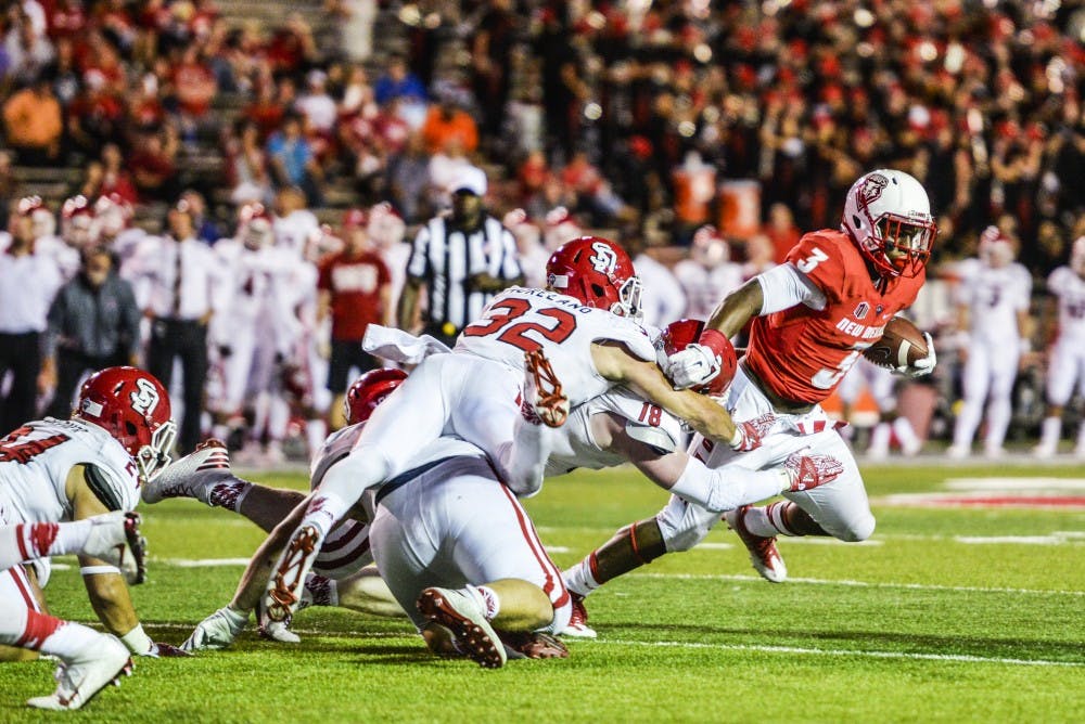 Junior running back Richard McQuarley evades a mob of South Dakota players on his way to the Lobo end zone on Thursday, Sept. 1, 2016 at University Stadium. The Lobos will face off against the New Mexico State Aggies Saturday in Las Cruces, New Mexico. 