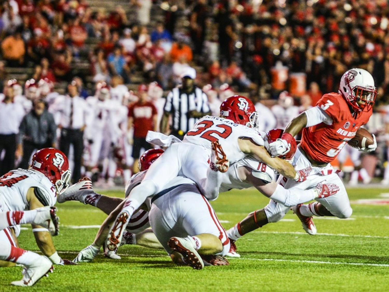 Junior running back Richard McQuarley evades a mob of South Dakota players on his way to the Lobo end zone on Thursday, Sept. 1, 2016 at University Stadium. The Lobos will face off against the New Mexico State Aggies Saturday in Las Cruces, New Mexico. 