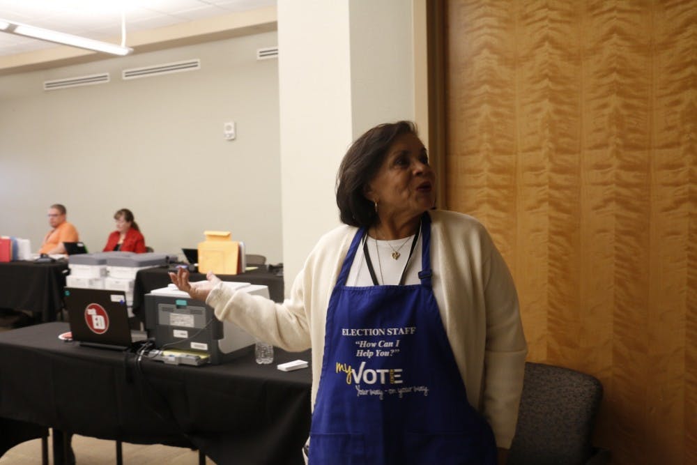A polling volunteer assists students at the early voting location at the UNM SUB during the 2016 election season.&nbsp;