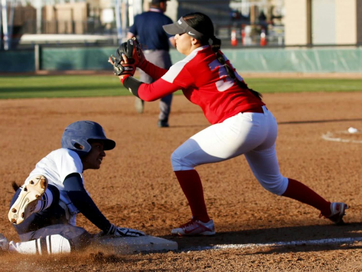 Junior infielder Jasmine Casados tries to tag out a Utah State player Saturday March 25, 2016 at the Lobo Softball Field. The&nbsp;Lobos lost two out of their three games against Nevada this past weekend.&nbsp;