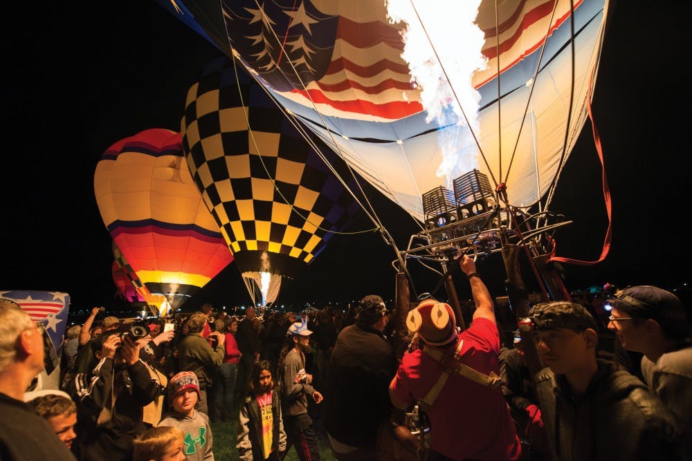 Dawn Patrol balloon crews participate in the morning glow by firing their burners in sync Sunday morning.