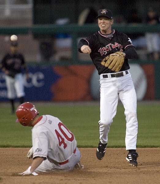 UNM's Coty Wilson slides into second base as Isotopes shortstop Chase Lambin turns a double play Wednesday. The Isotopes beat the Lobos 3-0 in an exhibition game.