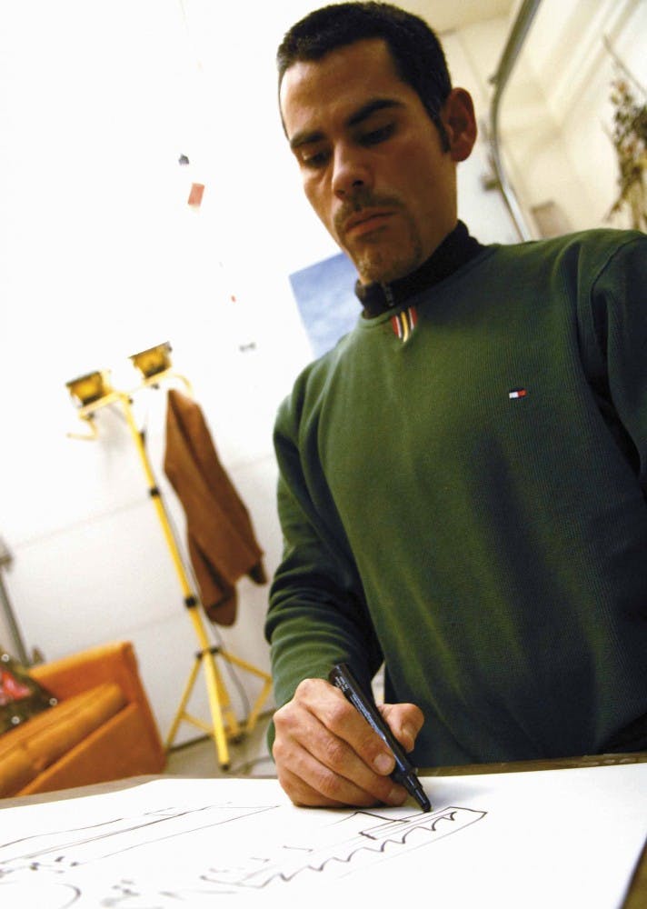 Artist Michael Olivares sketches a single-line drawing in his home studio on Tuesday.  "It's a very delicate idea of infinity and how anything can be captured with one line," Olivares said. 