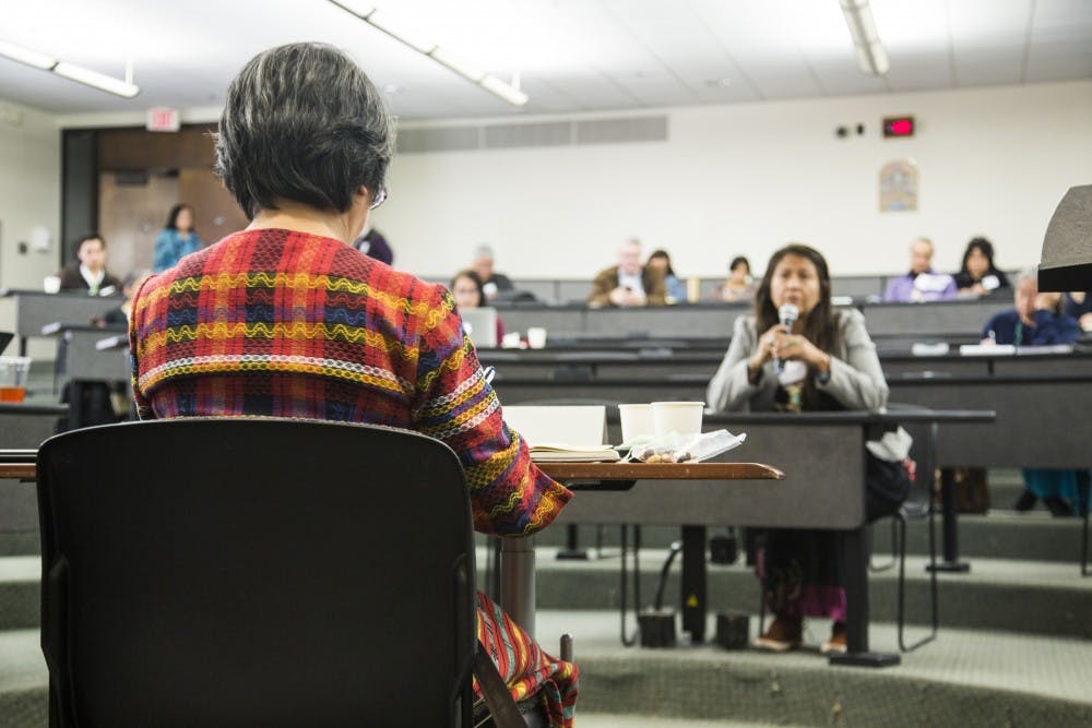 United Nations Special Rapporteur Victoria Tauli-Cortez listens to a woman who came to share her personal experiences at the Regional Indigenous Consultation hosted by the UNM School of Law on Saturday, Feb. 25, 2017.&nbsp;