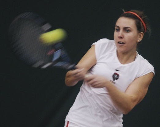 Mackenzie White whistles a shot at the UNM Tennis Complex on Saturday. The Lobos beat No. 43 South Florida, 4-3.