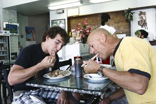 Michael Sanchez, left, eats fried rice with shrimp, and Pedro Moreno eats rice noodles with shrimp, beef and crab in soup at the 2000 Vietnam restaurant on Sunday. Moreno said the restaurant is reasonably priced with good service and is customer-oriented.