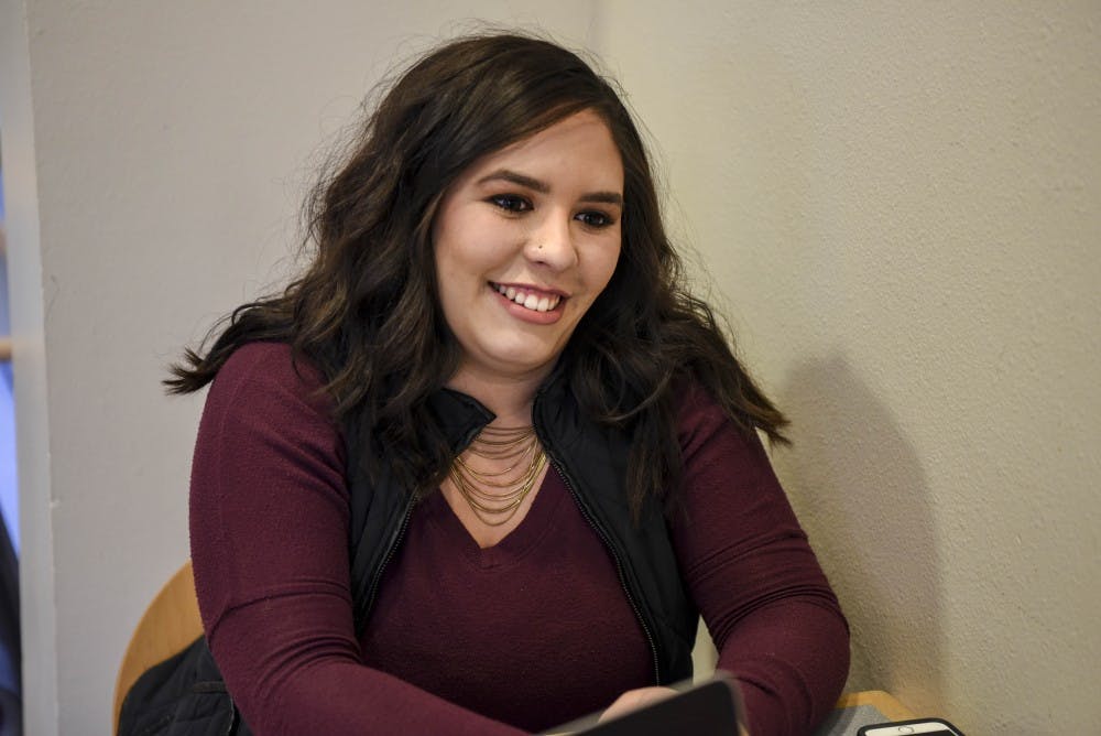 Elizabeth Laydon sitis in the Student Union Building on Dec. 8, 2017. She is graduating after five years, some of which she worked for the Southwest Film Center for mid-week movies.  