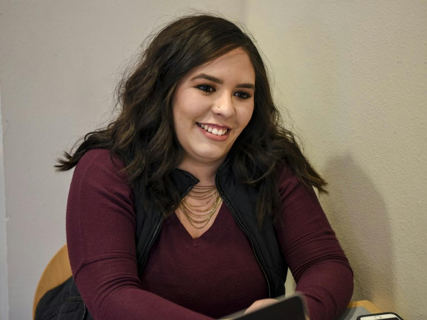 Elizabeth Laydon sitis in the Student Union Building on Dec. 8, 2017. She is graduating after five years, some of which she worked for the Southwest Film Center for mid-week movies.  