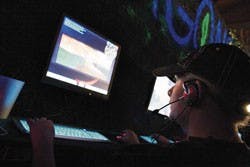 Heather King, wife of co-owner Thomas King, plays a first-person shooter game on a computer at the Dragon's Lair Ultimate Gaming Arena on Friday.  