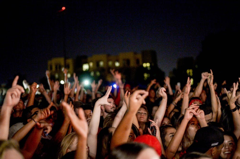 Hundreds of Lobo?s gathered at Red Rally Sept. 7, 2017 to watch a 25 foot NMSU Aggie burn, and to show support for the UNM football team. The crowd danced and bobbed along to the music in front of a stage.