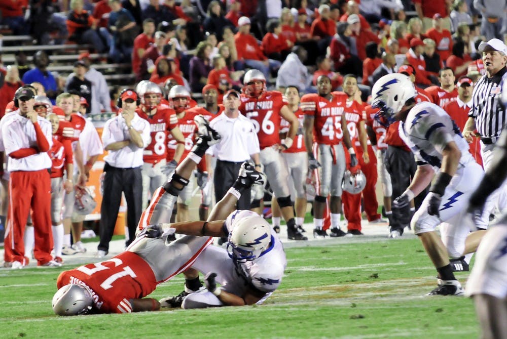 	Lobo quarterback Donovan Porterie is wrestled to the ground by an Air Force defender in UNM’s 37-13 loss on Saturday at University Stadium. The Lobos lost by double digits for the third consecutive week.