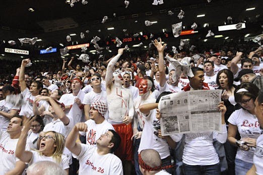 Students in Section 26 of The Pit shred and toss newspapers in the air during pre-game introductions Saturday. UNM beat UNLV 73-69.