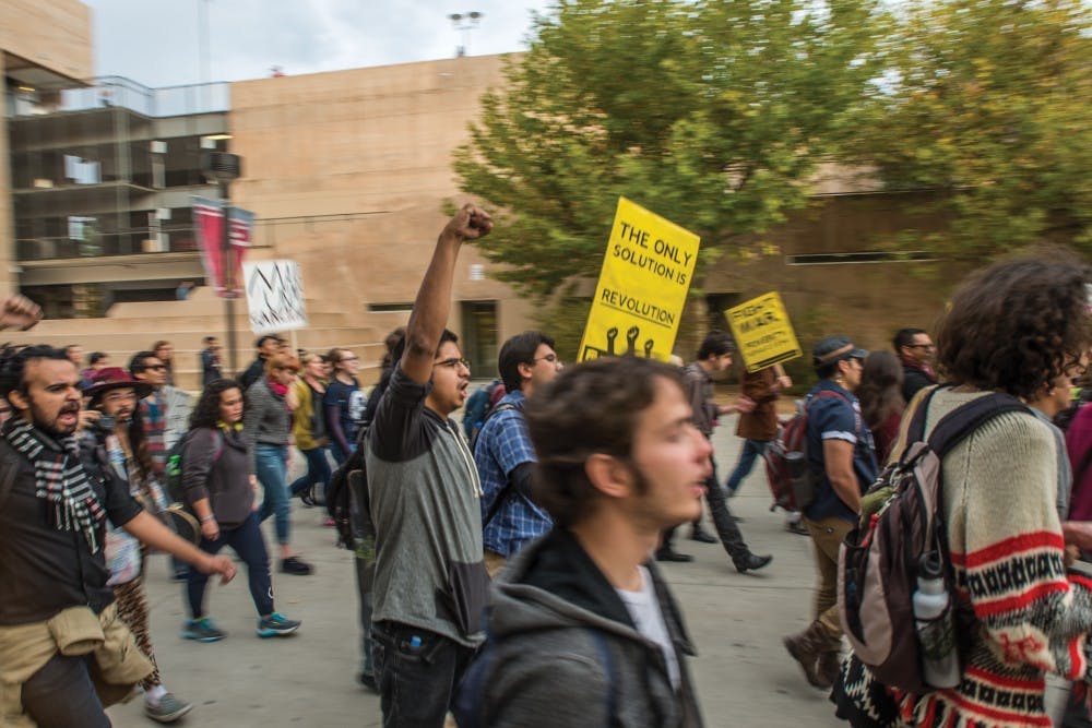 Protesters march through UNM’s Main Campus Wednesday, Nov. 16, 2016 as part of a University-wide march in solidarity against President-elect Donald Trump coming into office. Another walkout, organized by the UNM Young Progressives Demanding Action, is planned for Friday, the day Trump’s administration officially begins.