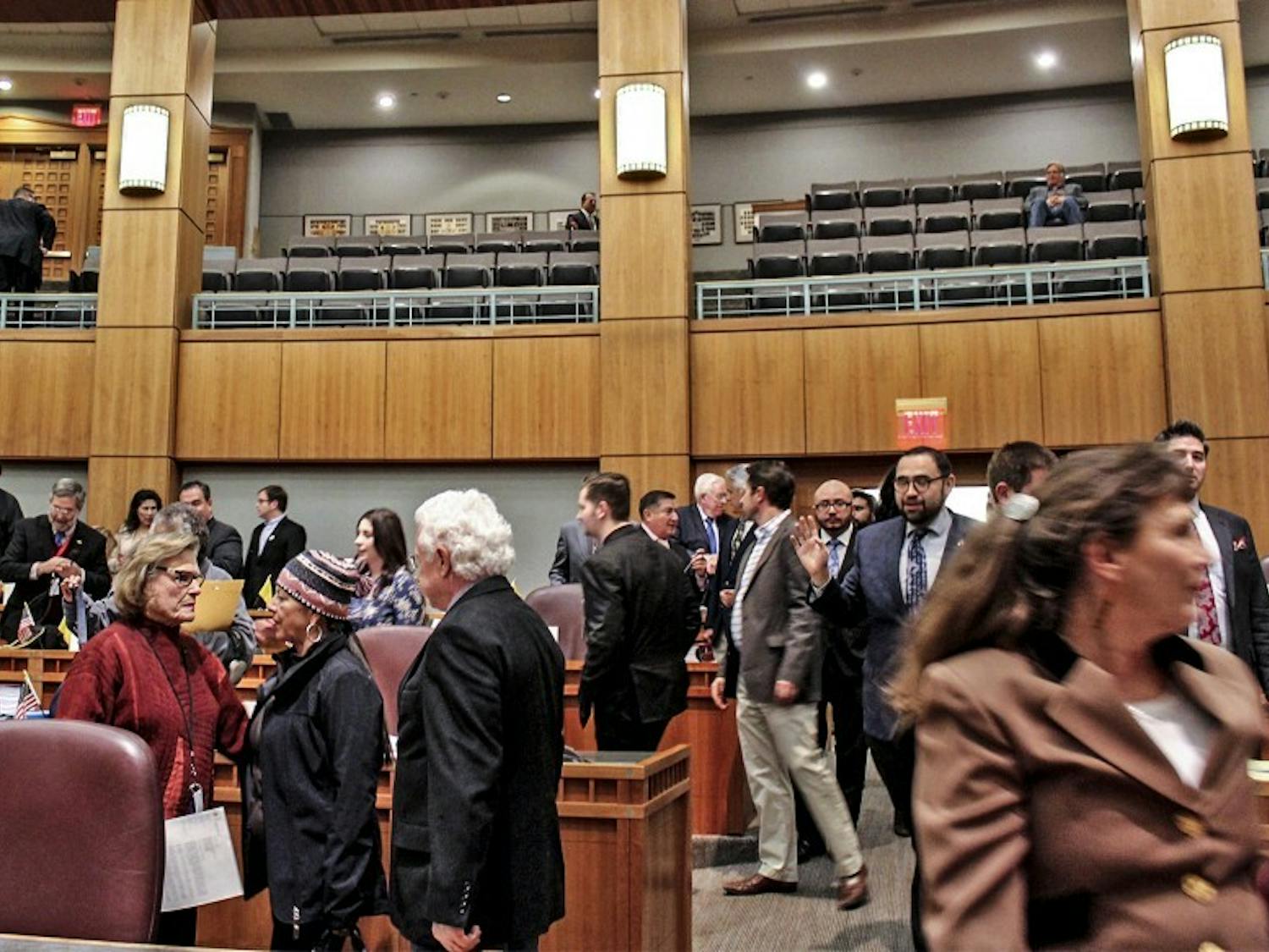Legislators, reporters, photographers and the public mingle and mumble as they make their way out of the Senate Chamber at the Santa Fe Roundhouse on Feb. 15, 2018.&nbsp;