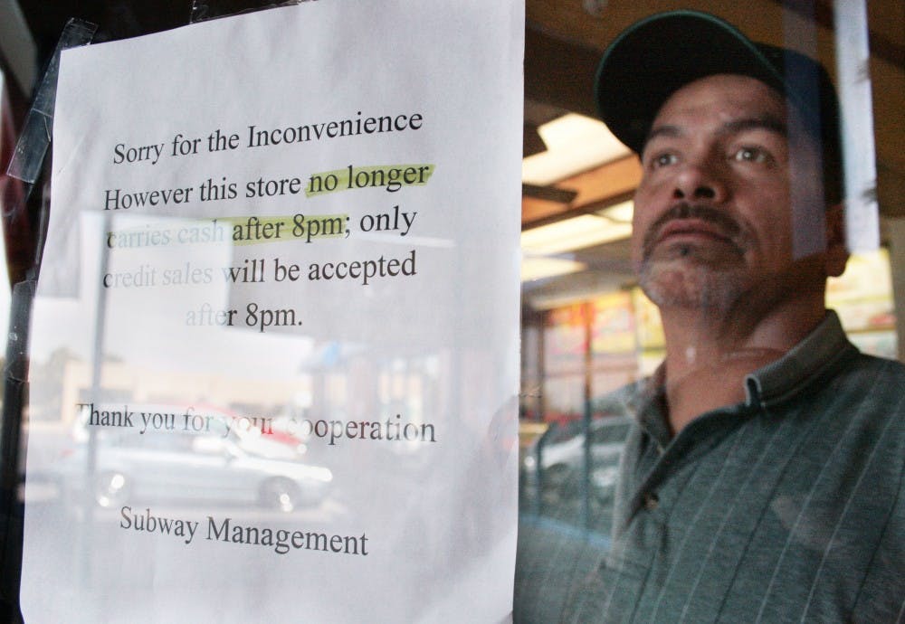 	Subway manager Eddie Dodson stares out the window of his restaurant on the corner of Girard Boulevard and Central Avenue on Monday. The restaurant has been robbed twice this year.