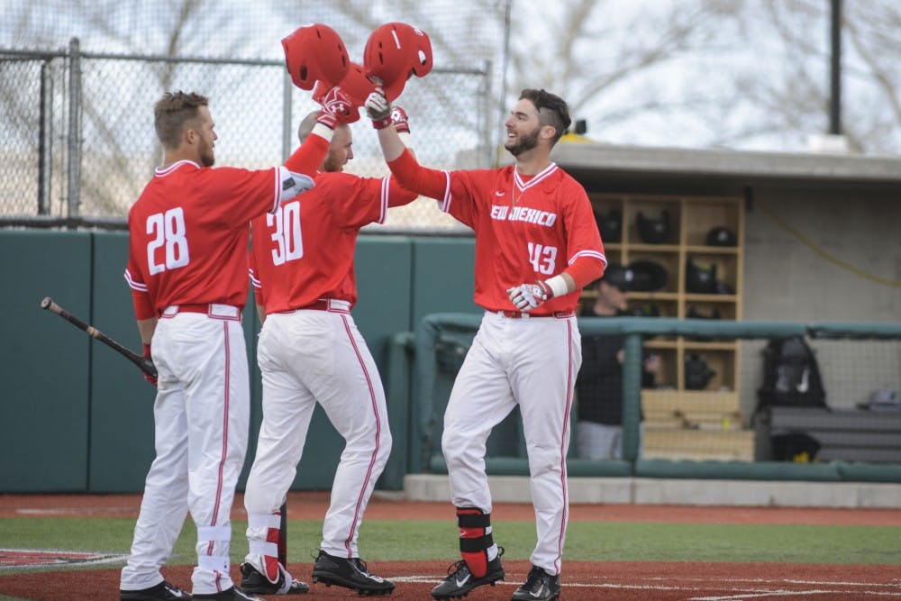 A group of Lobo players come together at home plate to celebrate scoring against Bringhamton Sunday, Feb. 19, 2017 at Santa Ana Star Field.&nbsp;