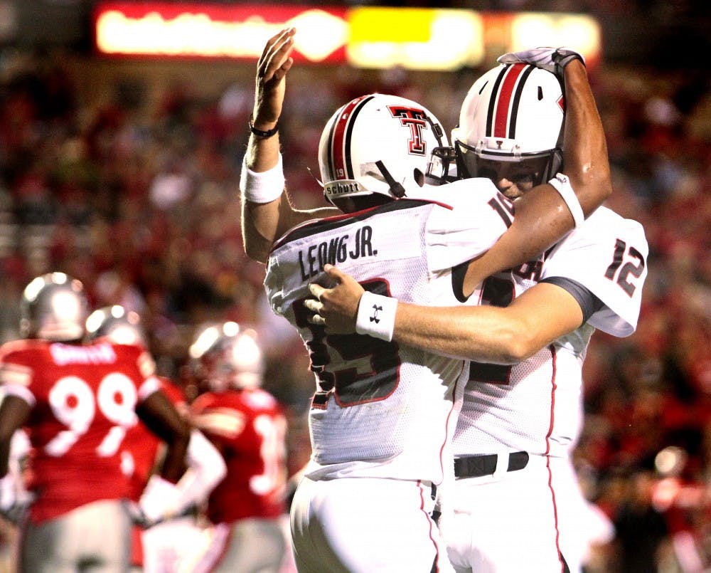 	Texas Tech quarterback Taylor Potts embraces wide receiver Lyle Leong for the final touchdown by the Red Raiders on Saturday at University Stadium. Texas Tech racked up 310 passing yards on the UNM defense en route to a 52-17 victory.