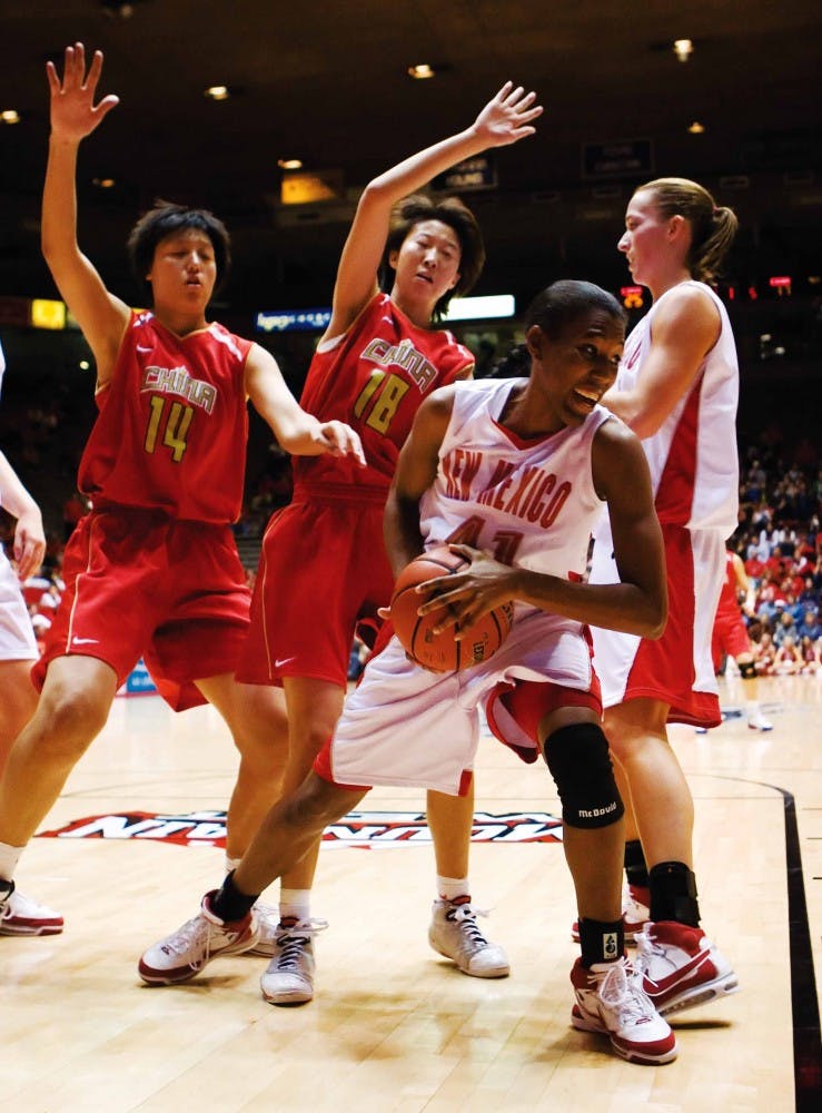 UNM's Brandi Kimble, right, protects the ball from Lixin Chen, left, and Xiaoni Zhang during the first half of Thursday's exhibition game against China's national basketball team at The Pit. 