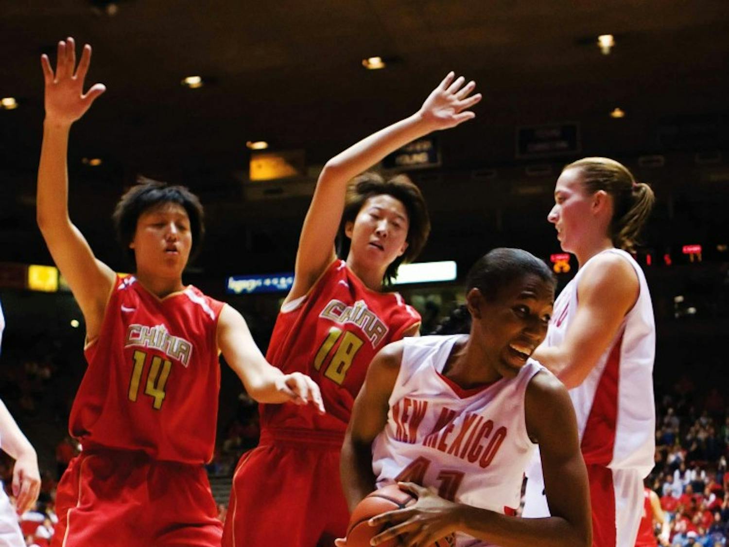 UNM's Brandi Kimble, right, protects the ball from Lixin Chen, left, and Xiaoni Zhang during the first half of Thursday's exhibition game against China's national basketball team at The Pit.