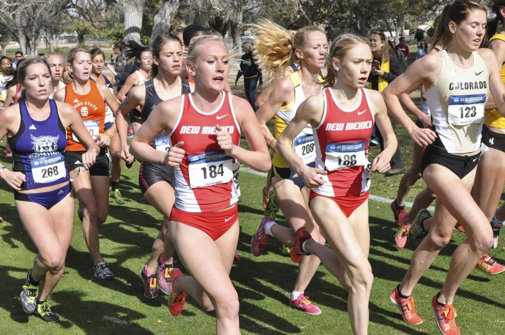 New Mexico junior Calli Thackery (184) and freshman Alice Wright (186) run side-by-side at the NCAA Mountain Region Cross Country Championships at UNM North Golf Course on Friday.  Wright went on to take first with a time of 20:51.10.
