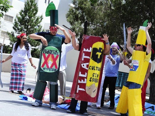 Jaime Herrera (Dos Equis), left, Elizabeth De Luna (Tecate), center, and Alberto Camacho (Corona) perform a skit in recognition of Cinco de Mayo on Tuesday in front of Mesa Vista Hall.